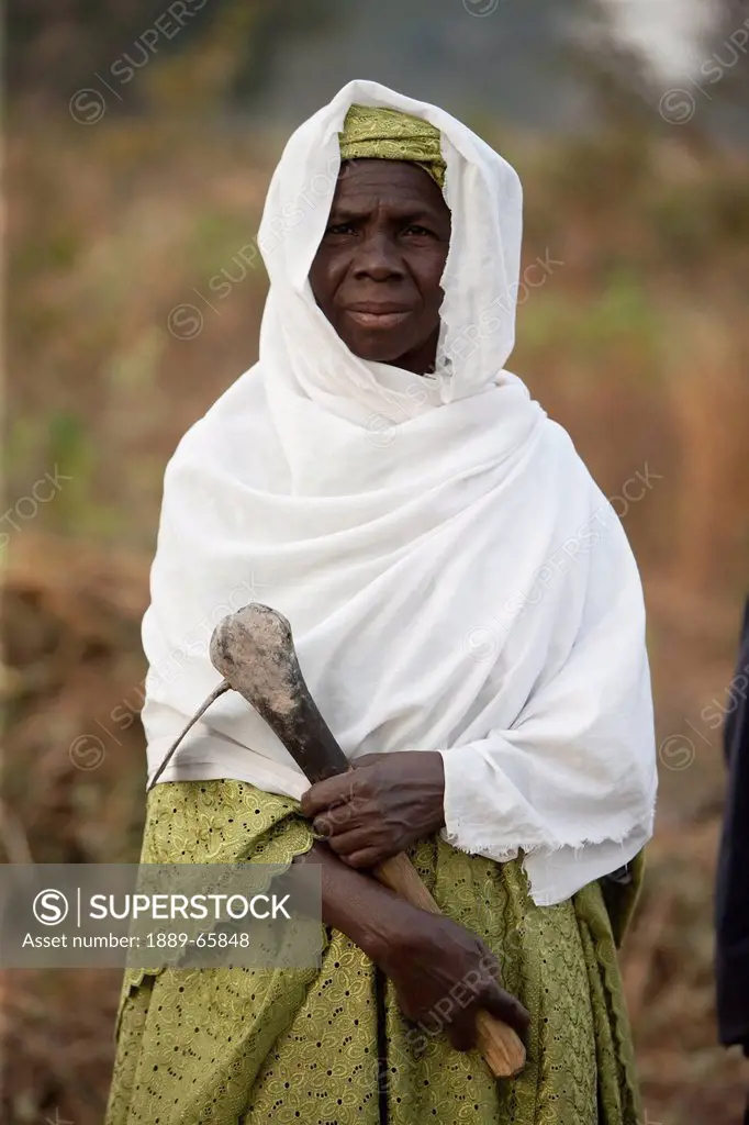 portrait of a woman holding a carved item, senegal