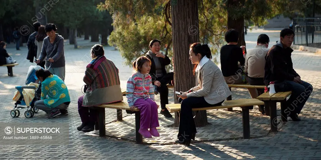 people relaxing outside the temple of heaven, beijing, china