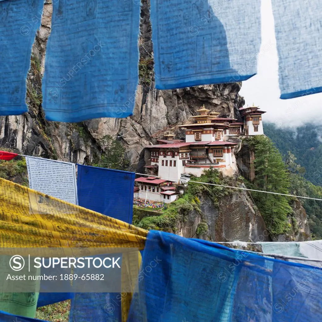 prayer flags hanging in front of tiger´s nest monastery, paro district bhutan