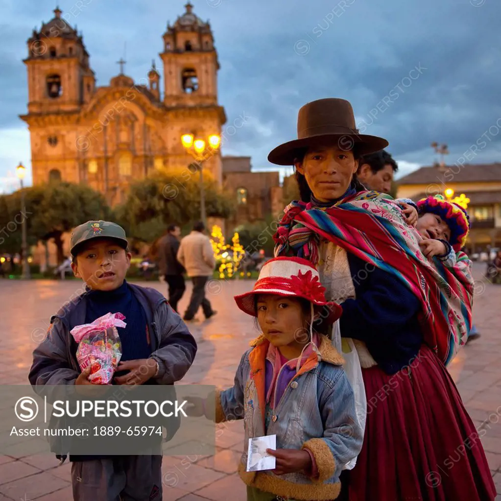 A Woman With Three Children In The Plaza De Armas, Cusco Peru