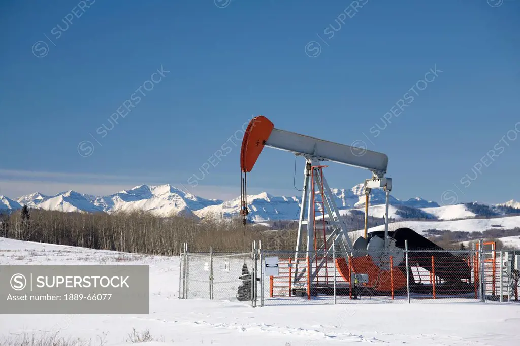 oil industry pumpjack in winter, longview, alberta, canada