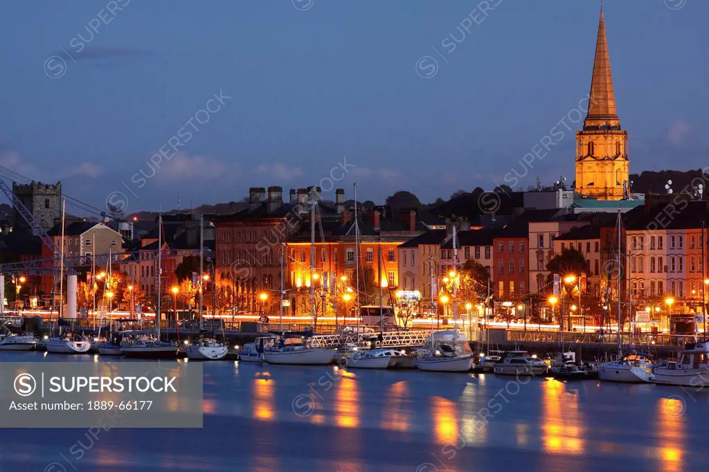boats moored on river suir at city waterfront at night, waterford city, county waterford, ireland