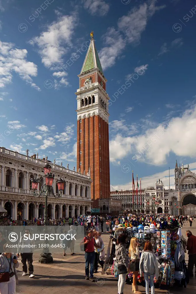 bell tower in st. mark´s square and street vendors selling their wares, venice italy