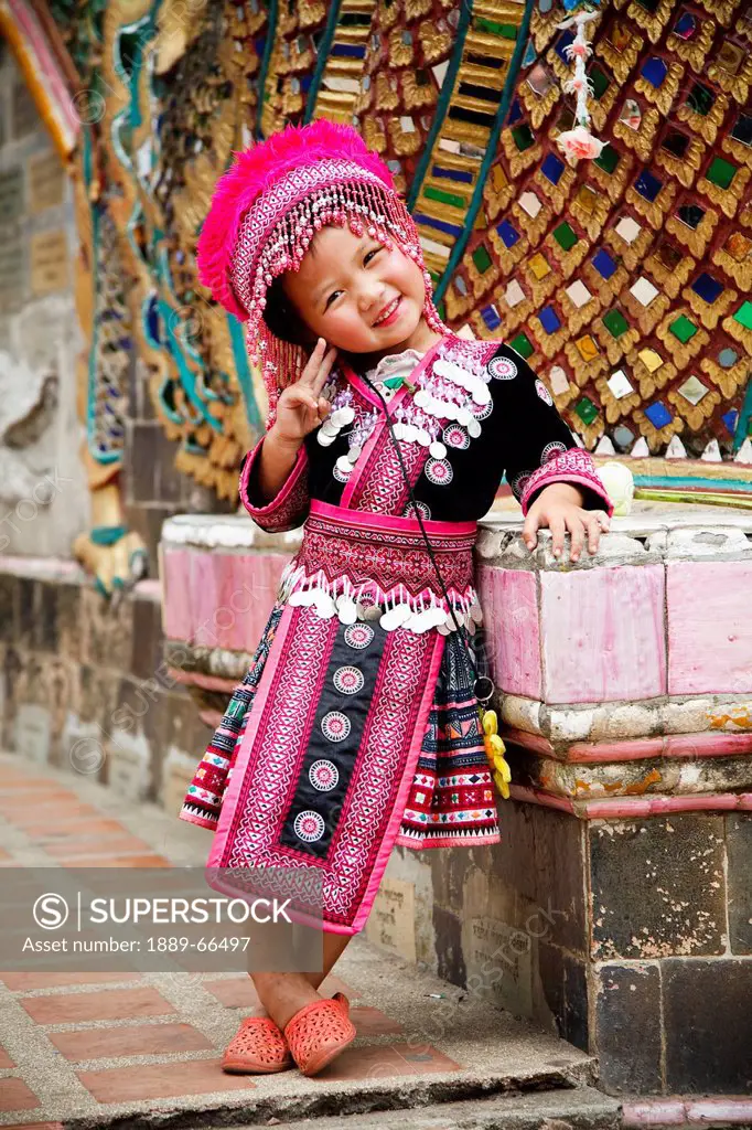 thai child poses in traditional dress, chiang mai thailand