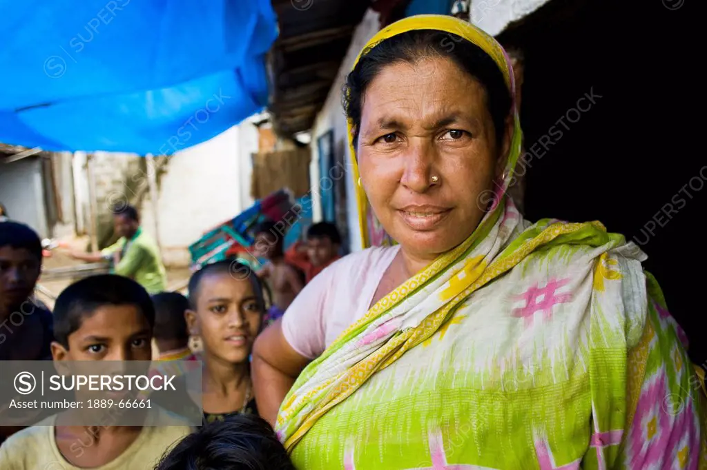 A Woman Standing With Children In The Slums, Sylhet, Bangladesh