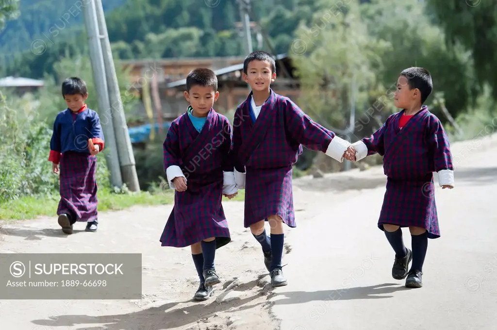 Bhutanese Schoolchildren Walking On Road, Chokhor Valley Bhutan