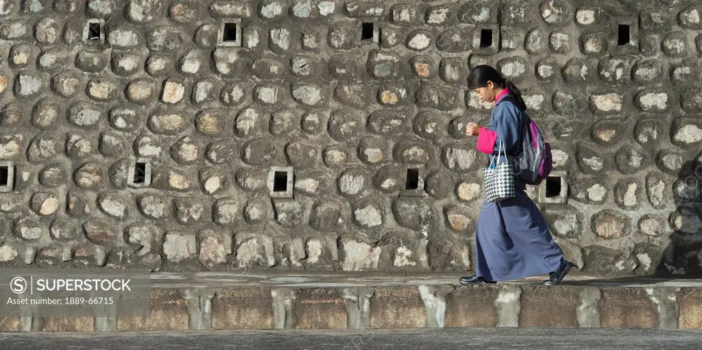 Woman Walking By Stone Building, Thimphu Bhutan