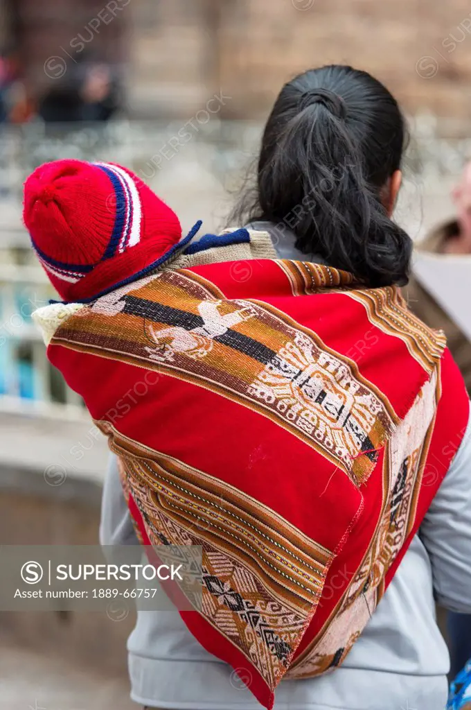 A Woman Carries A Baby On Her Back, Cusco Peru