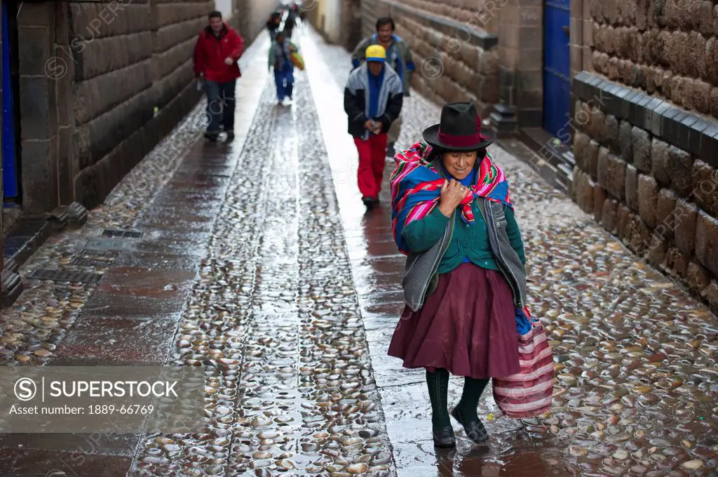 People Walking Up The Wet Street, Cusco Peru
