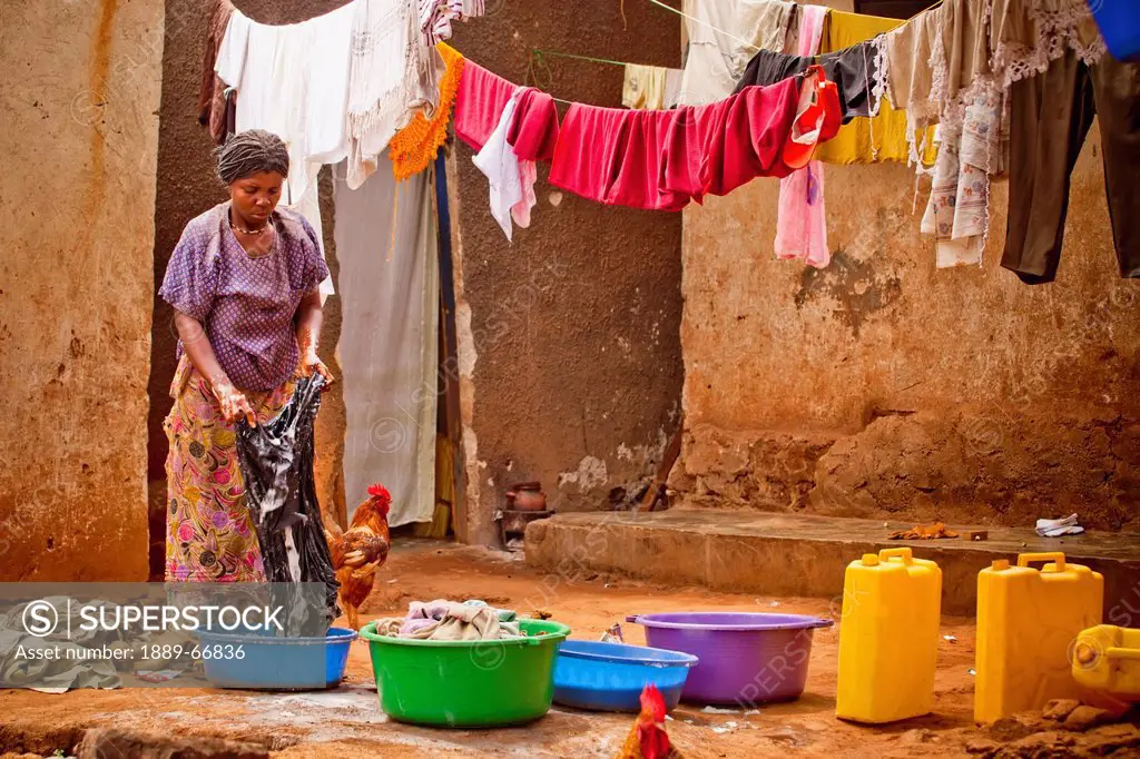 A Woman Washing Clothes In A Basin, Kampala Uganda Africa