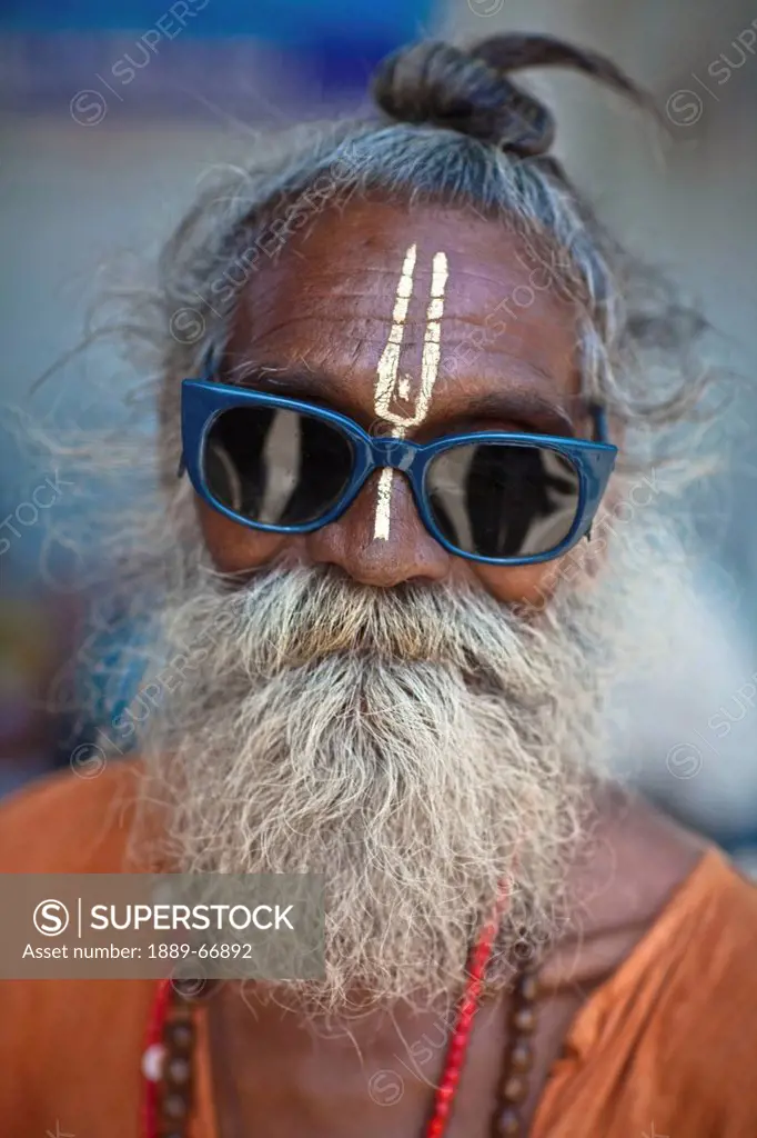 A Holy Man Wearing Sunglasses With A Third Eye Painted On His Forehead, Haridwar India