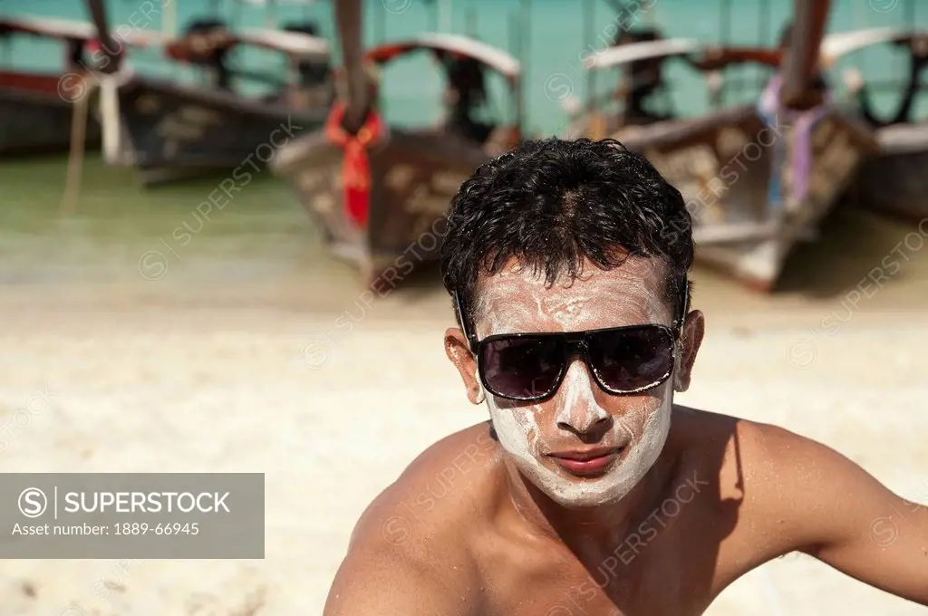 boy with powder on his face celebrating songkran a festival for the thai new year, phi phi islands thailand