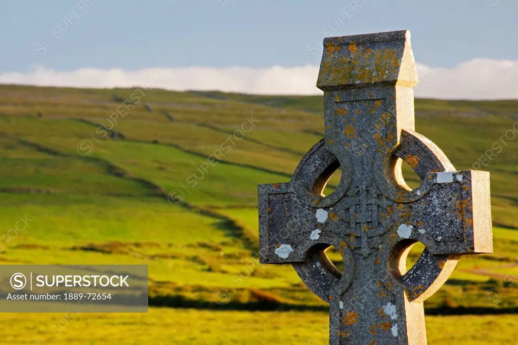 celtic cross in a cemetery in the burren region, fanore county clare ireland