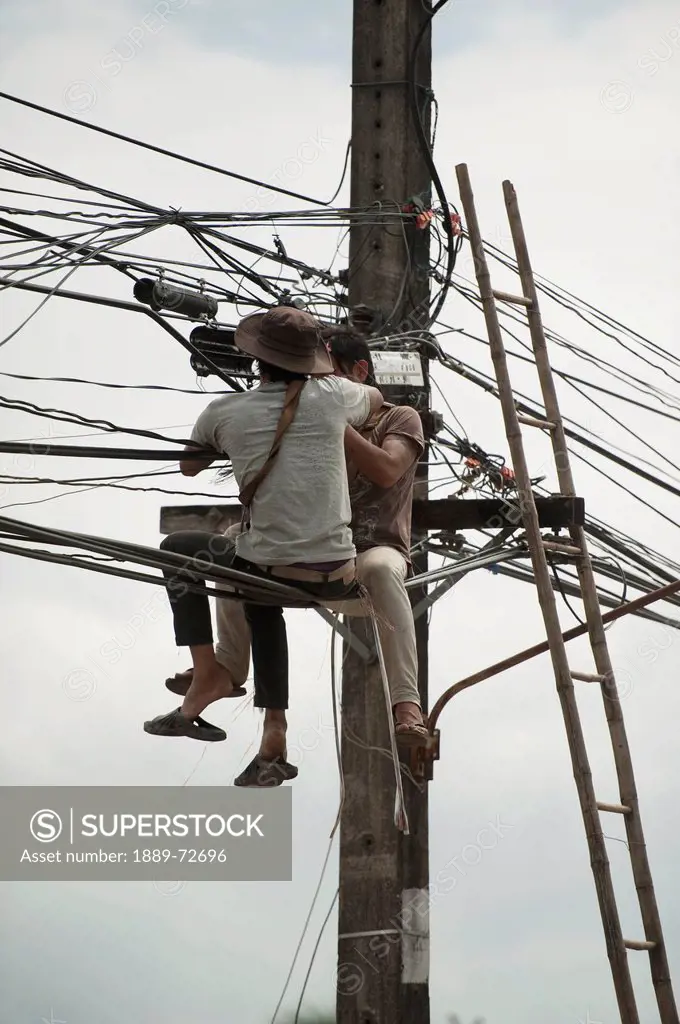 technicians working on the wires, mae sot thailand