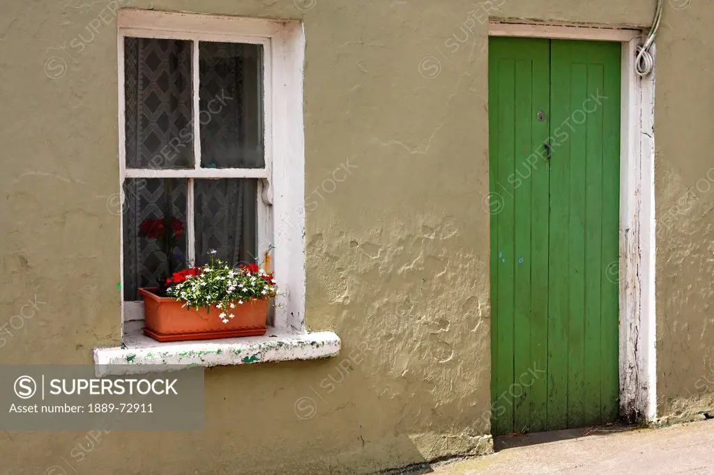 house with a green door in eyeries village on the beara peninsula in west cork, county cork ireland