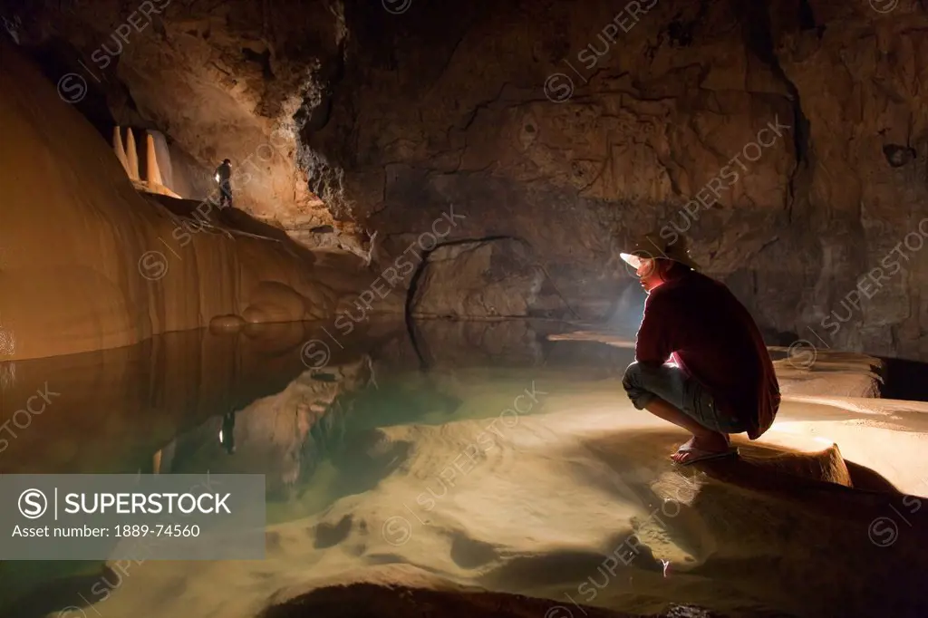 A Filipino Tour Guide Holds A Lantern Inside Sumaging Cave Or Big Cave Near Sagada, Luzon Philippines