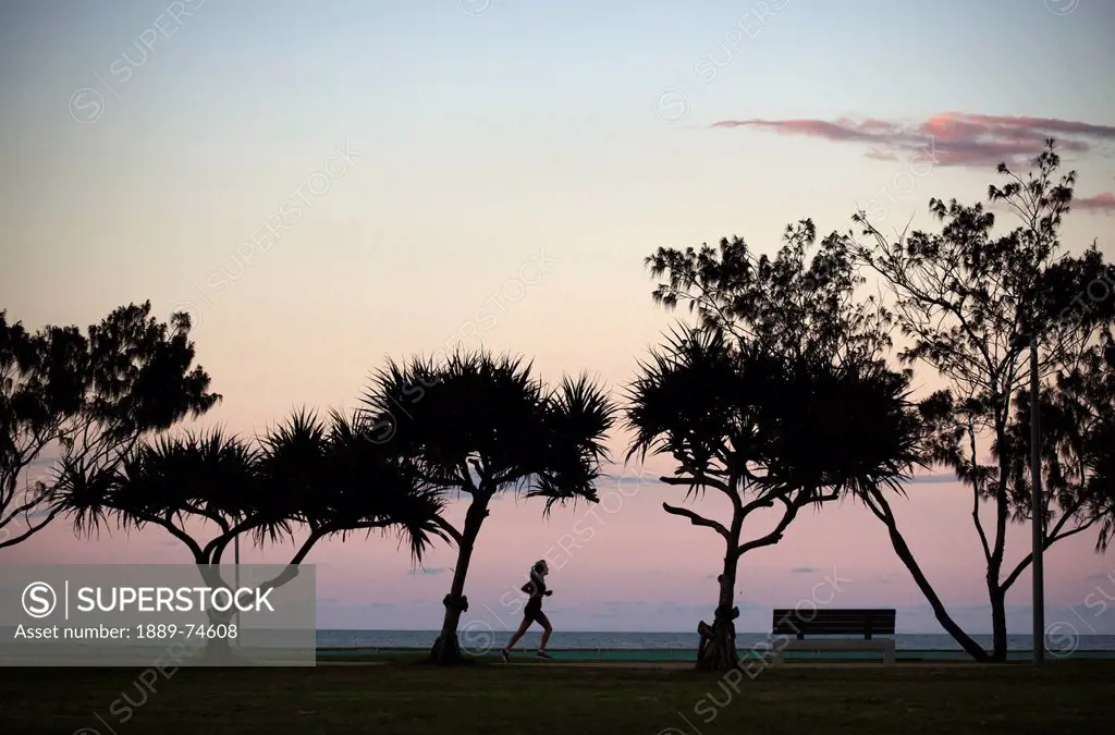 Silhouette Of A Woman Running Along Kirra Beach, South Gold Coast Queensland Australia