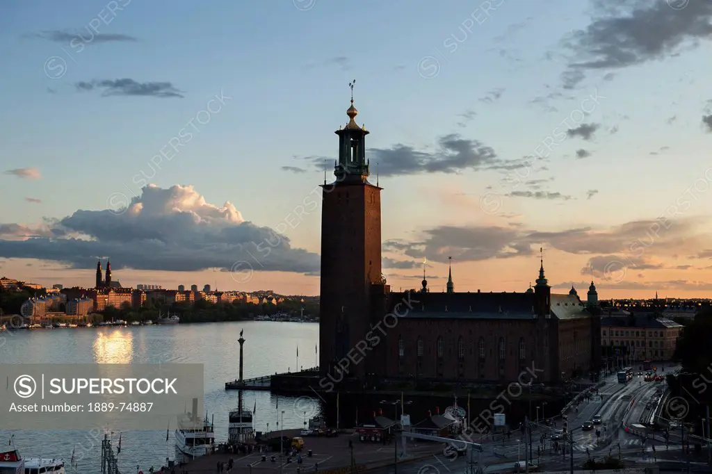 City hall along the water´s edge at sunset, stockholm sweden