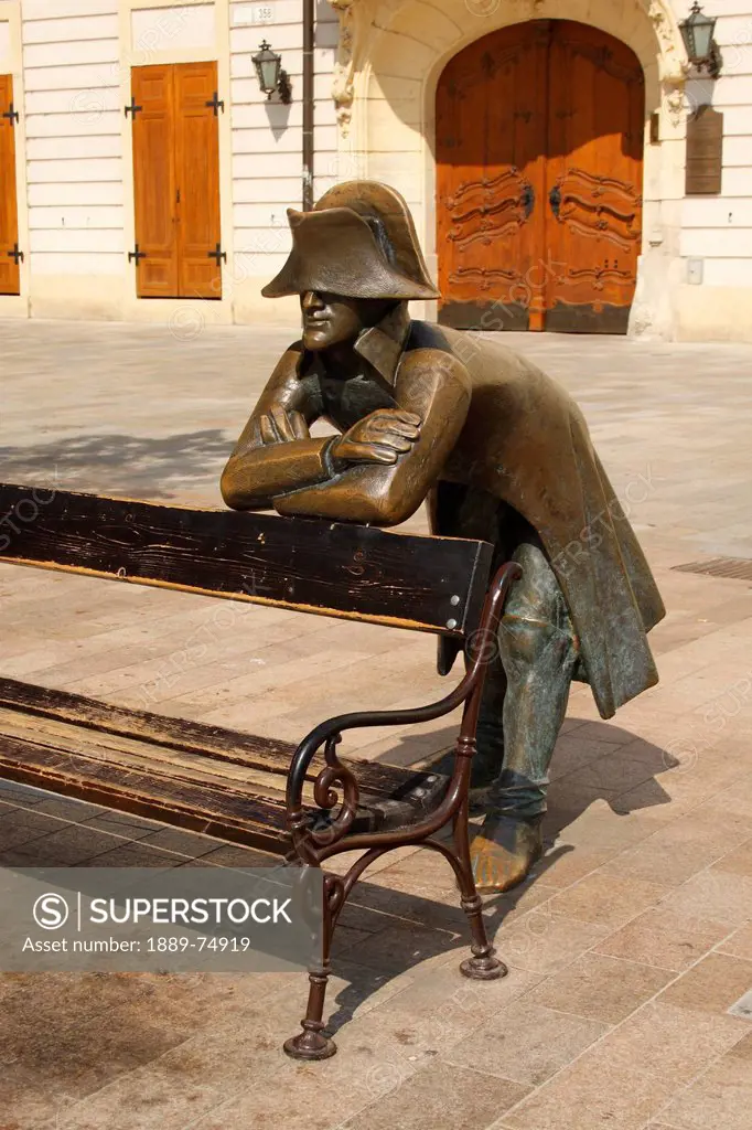 Bronze statue of a soldier leaning on a bench in front of the french embassy, bratislava slovakia