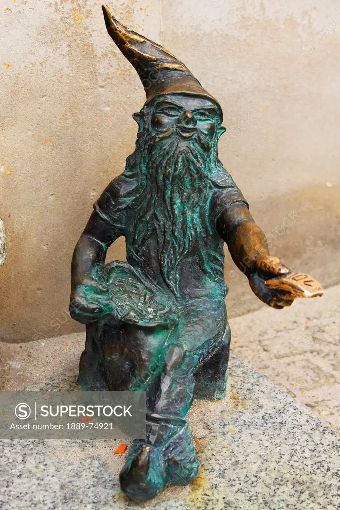 Bronze sculpture of a gnome beside a cash point, wroclaw poland