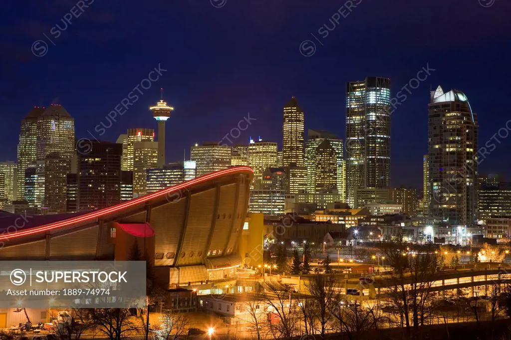 Calgary skyline with saddledome at dusk with city lights, calgary alberta canada