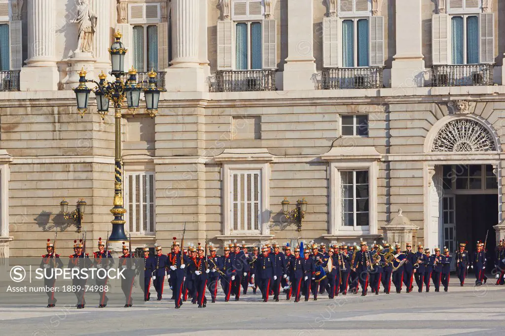 The royal palace with foot soldiers of the royal guard in traditional uniforms, madrid spain