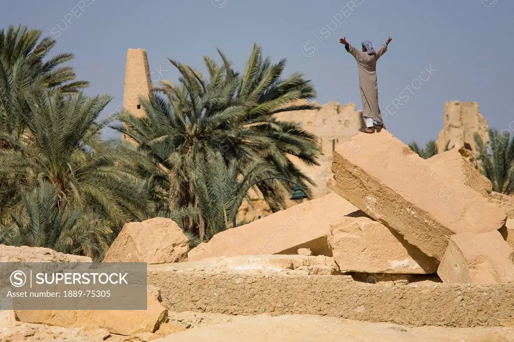 A Local Siwan Man Raises His Arms Into The Air In Siwa At The Siwa Oasis, Siwa Egypt