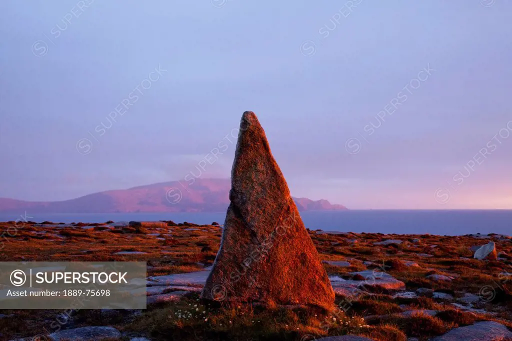 A unique rock formation in a peak near blacksod bay with achill island in the background, county mayo ireland