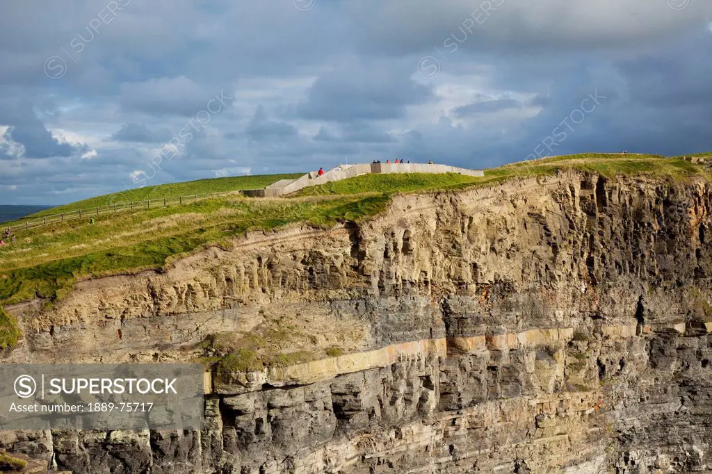 People on a lookout point at the top of the cliffs of moher, county clare ireland