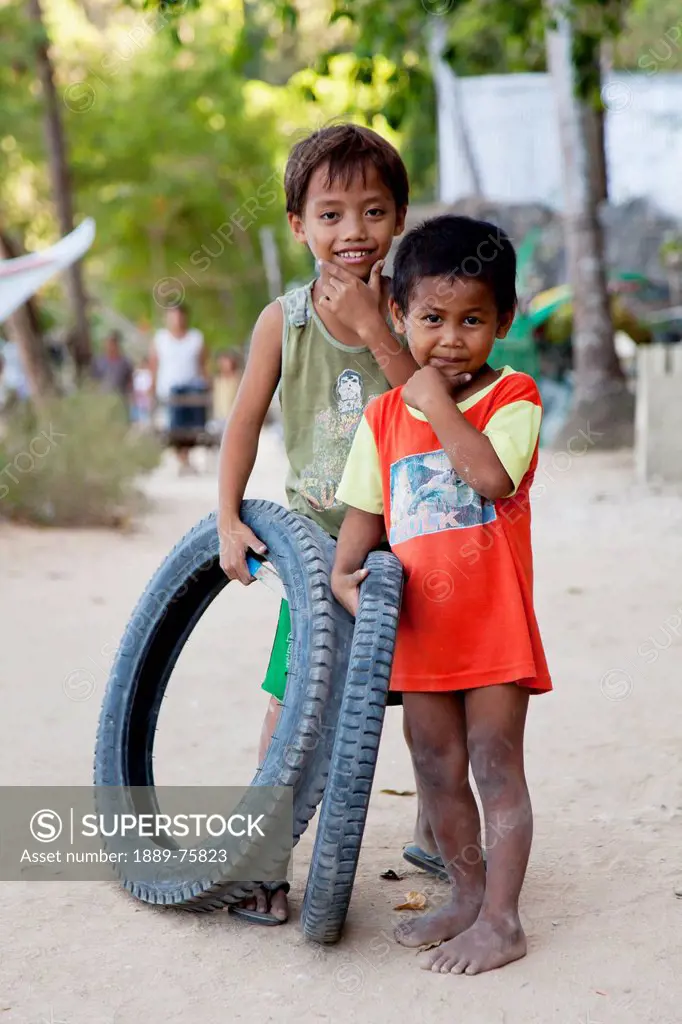 Two Young Boys With Their Toy Tires In A Village, El Nido Bacuit Archipelago Palawan Philippines