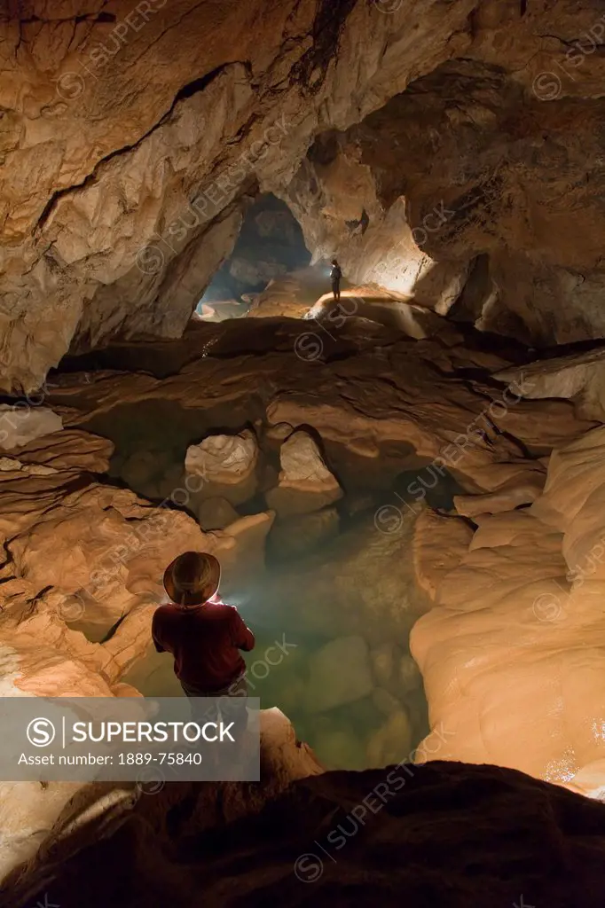 A Filipino Tour Guide Holds A Lantern Inside Sumaging Cave Or Big Cave Near Sagada, Luzon Philippines