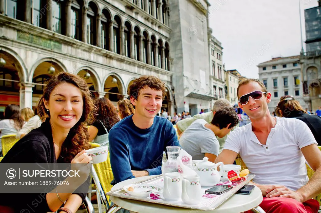 Friends Enjoying Coffee On Saint Mark´s Square, Venice Italy