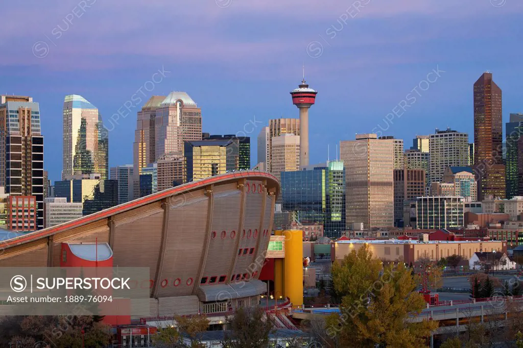 Calgary Skyline With The Saddledome Calgary Tower And Buildings At Dawn With Deep Blue Sky And Magenta Clouds, Calgary Alberta Canada
