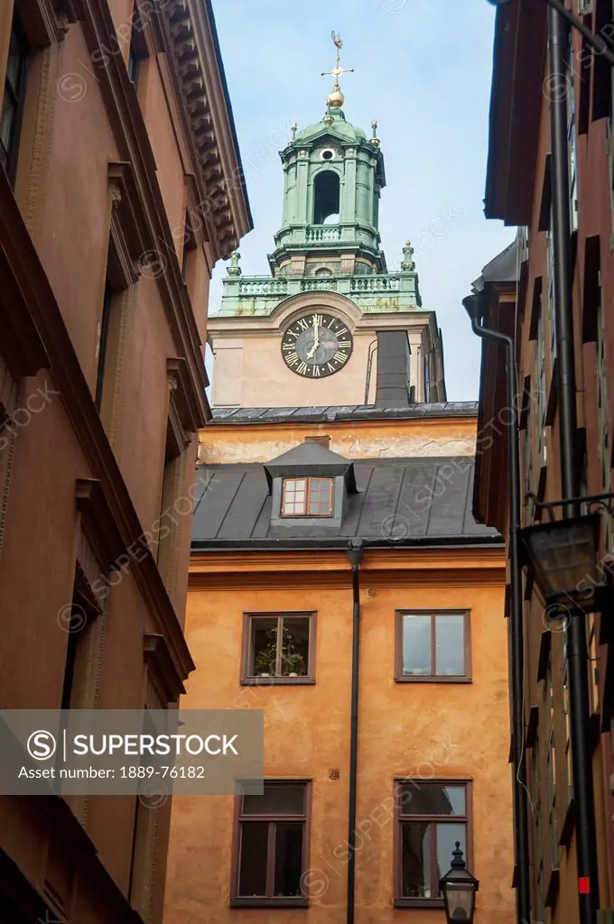 Clock tower on a church rising above the rooftops in old town, stockholm sweden