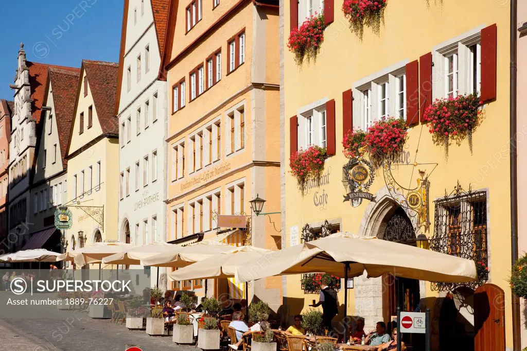 Umbrellas over tables along the street at the marketplace, rothenburg ob der tauber bavaria germany