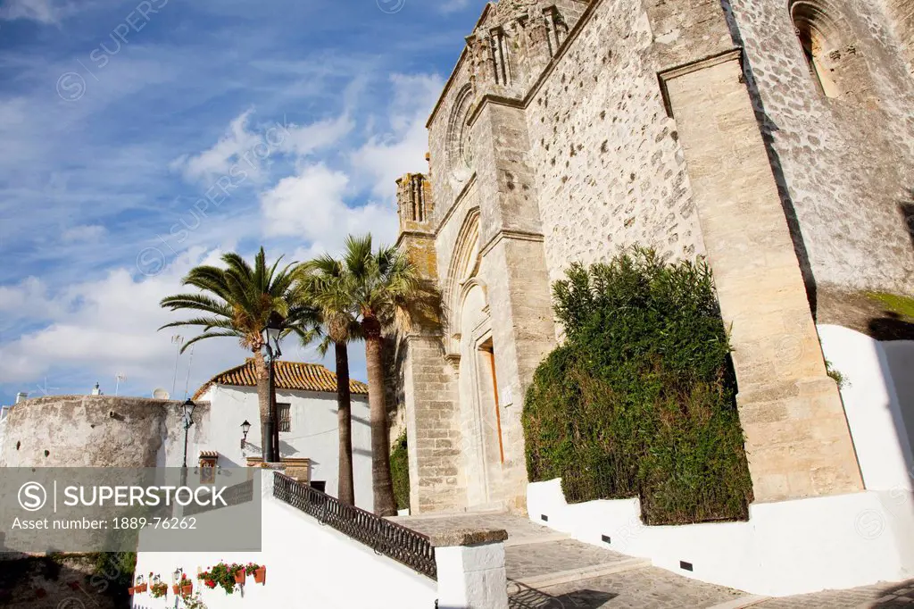 Sloped ramp beside a building with palm trees and plants, vejer de la frontera andalusia spain