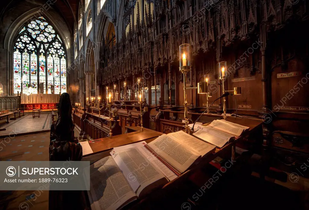Open bibles and candles illuminated in ripon cathedral, ripon yorkshire england