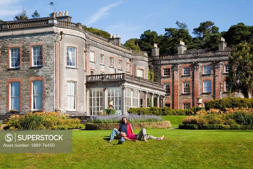 A couple relaxes on the lawn at bantry house, bantry county cork ireland