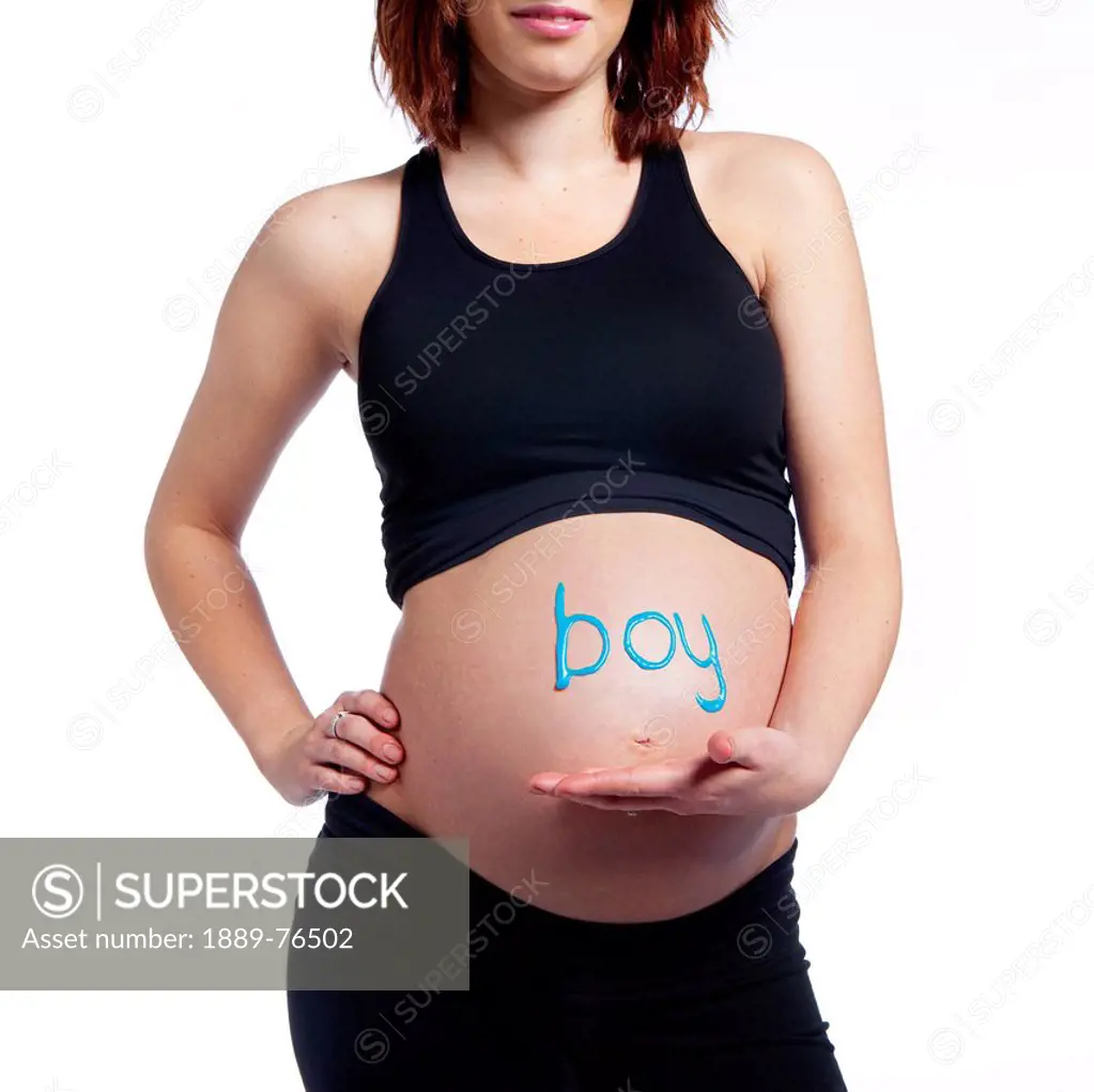 A woman´s pregnant belly with the word boy written on it, edmonton alberta canada