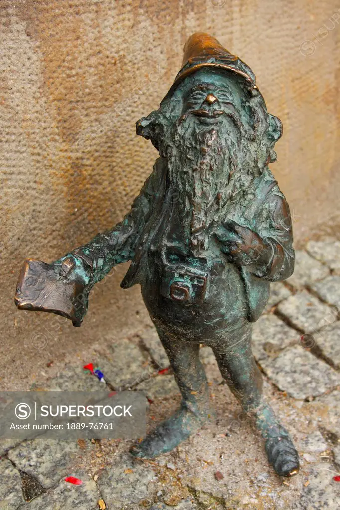 Bronze sculpture of a gnome outside the tourist office, wroclaw poland
