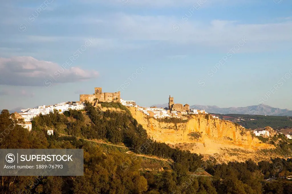 View of the town on a hill with mountains in the background, arcos de la frontera andalusia spain