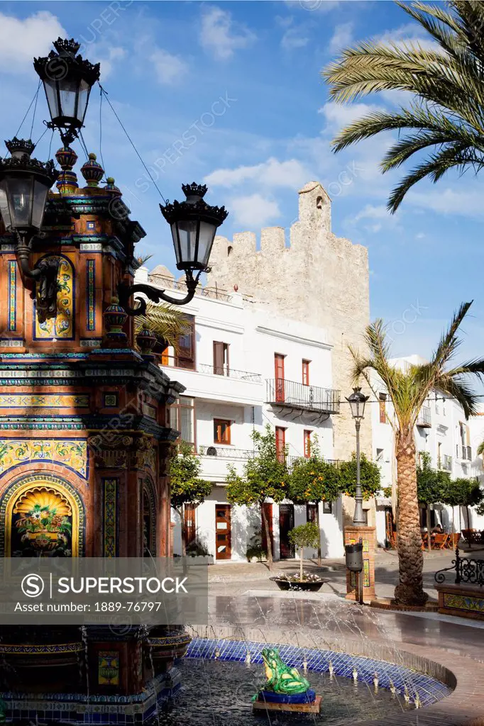 A water fountain and palm trees in the town, vejer de la frontera andalusia spain