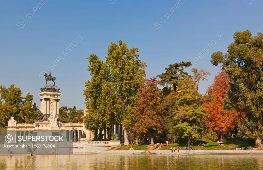 The lake in el retiro gardens with the monument to king alfonso xii in background, madrid spain