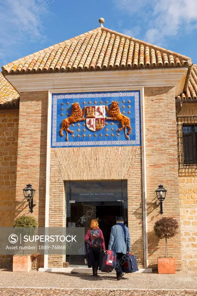 Coat of arms of pedro i the cruel king of castille above main entrance of parador alcazar del rey don pedro, carmona seville province spain