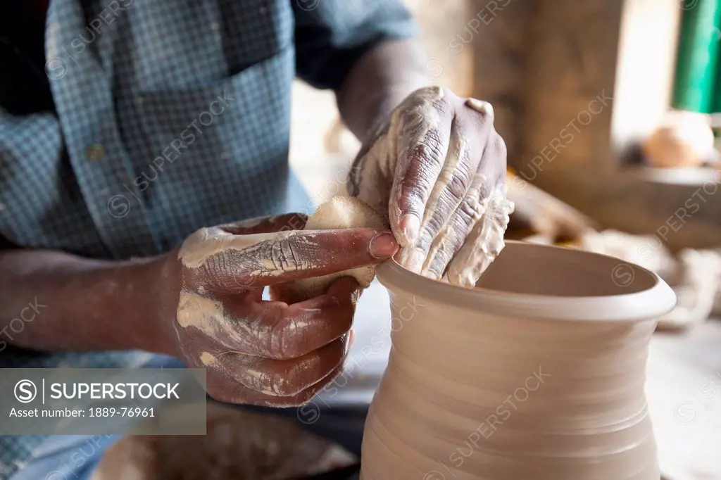 A potter forms the clay on a pottery´s wheel, kodaikanal tamil nadu india