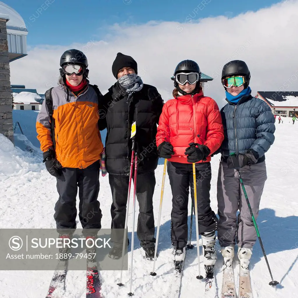 four skiers ready to go at a ski resort, whistler british columbia canada