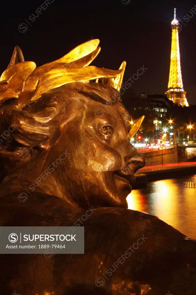 night lights of the eiffel tower and the river seine as seen from the pont alexandre ii, paris france