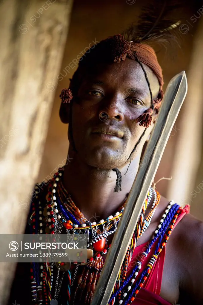Portrait Of A Young Man In Traditional Clothing Holding A Staff, Masai Mara Kenya