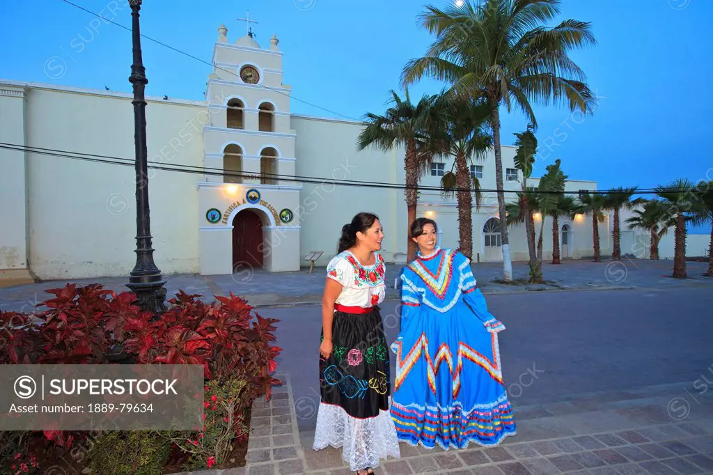 women in traditional folkloric dresses downtown in the early morning, todos santos baja california sur mexico
