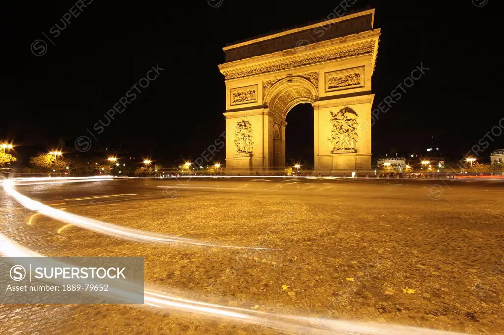 traffic light trails around the arc de triomphe, paris france